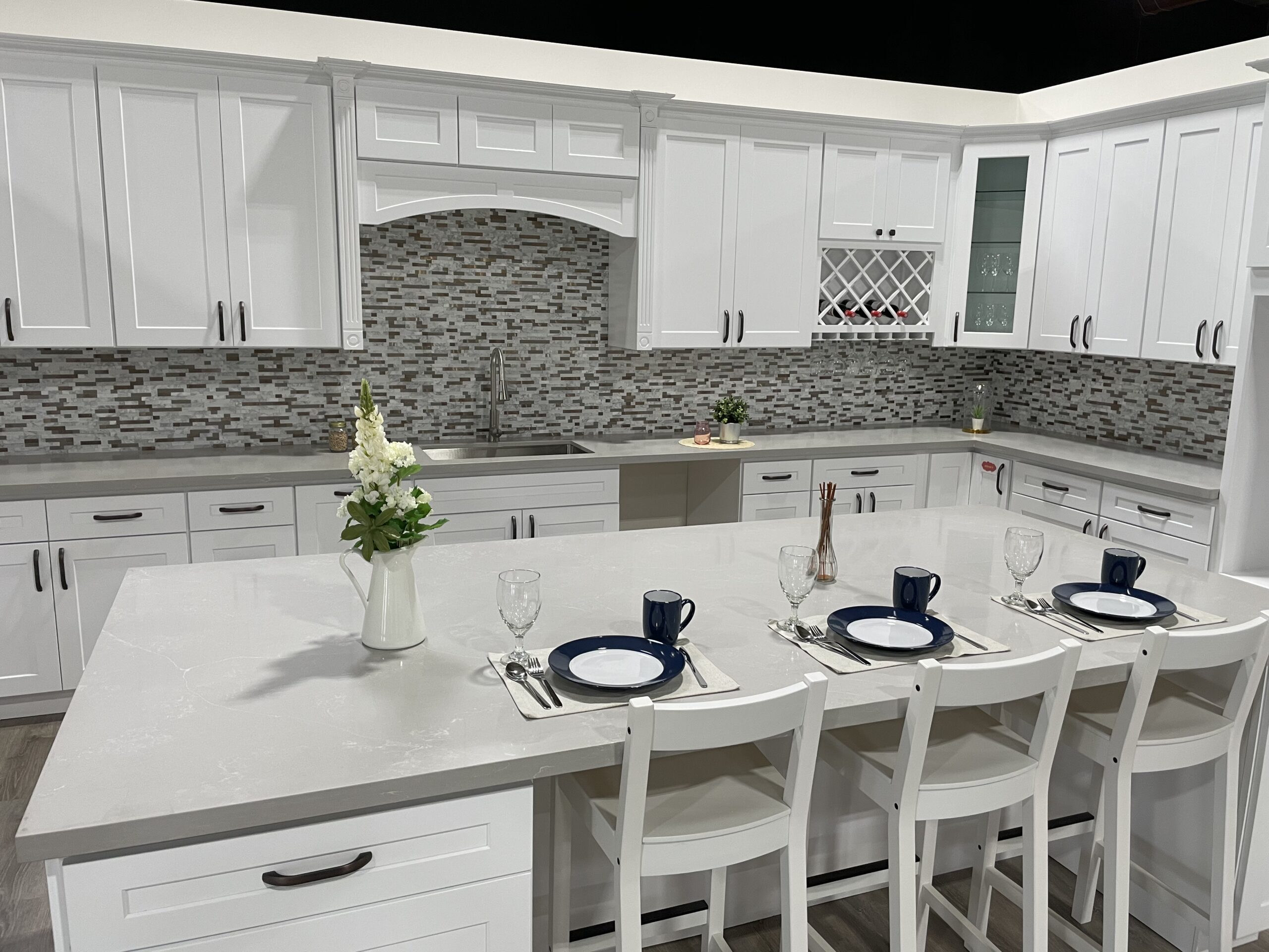 Krafter's Land showroom kitchen with white shaker cabinets and quartz countertops